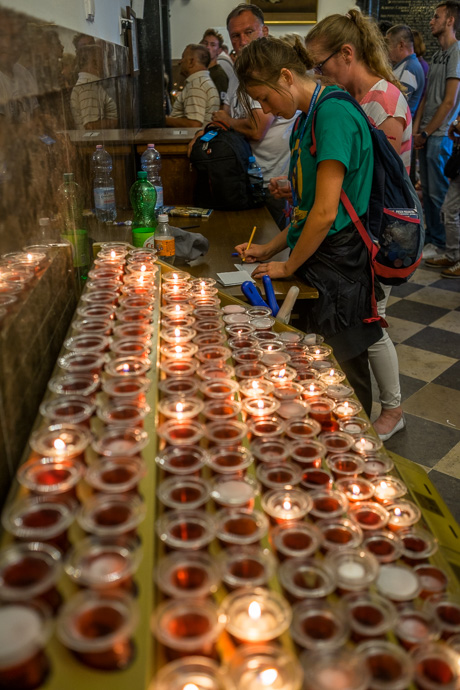 Celebration of Maria ascension in Jasna Góra, Poland 2018. A young woman writes her intention on a piece of paper for confirmation. Image: Michel Meijer
