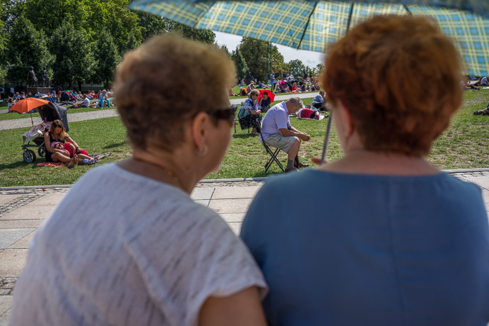 Celebration of Maria ascension in Jasna Góra, Poland 2018. People attend the religious service held on the field in front of the Jasna Góra pilgrimage site. Image: Michel Meijer