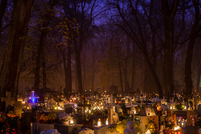 All Saints' Day at Rakowicki Cemetery in Kraków, Poland 2019. Gravestones in a cemetery are lit by candles, All Saints' Day in Poland. Image: Michel Meijer