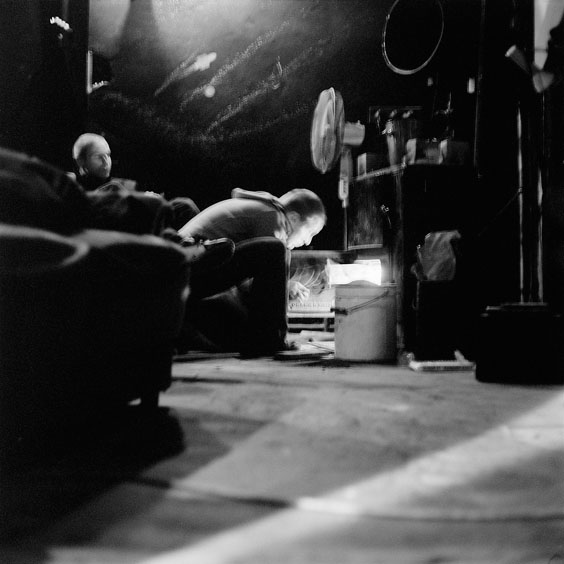 Friday, February 14, 2003. Durchsfenster - The February program 2003 An employee fires up the coal heater to keep the projection room warm. Image: Michel Meijer