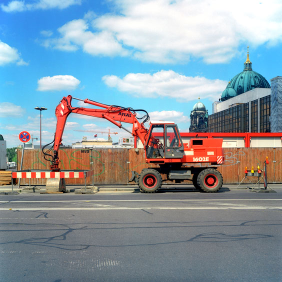 A red excavator in a street in Berlin. Image: Michel Meijer