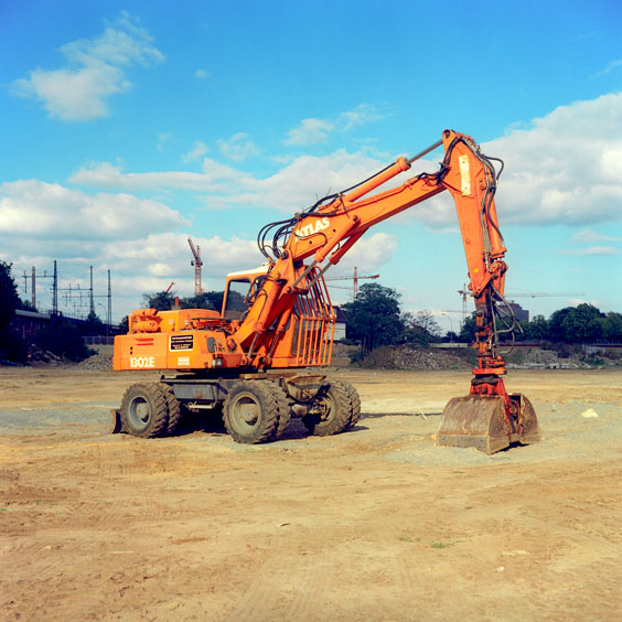 An orange excavator on a construction site in Berlin. Image: Michel Meijer